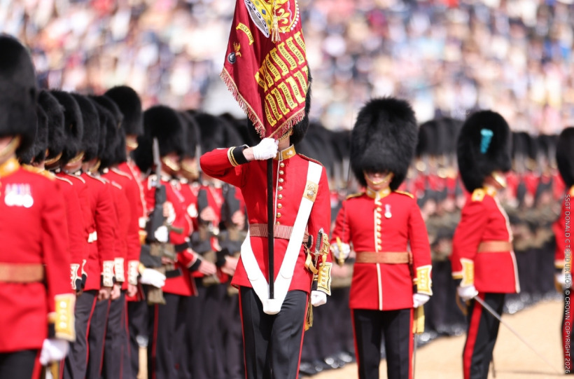 The Regimental Colour is trooped down the ranks of soldiers at Horse Guards Parade