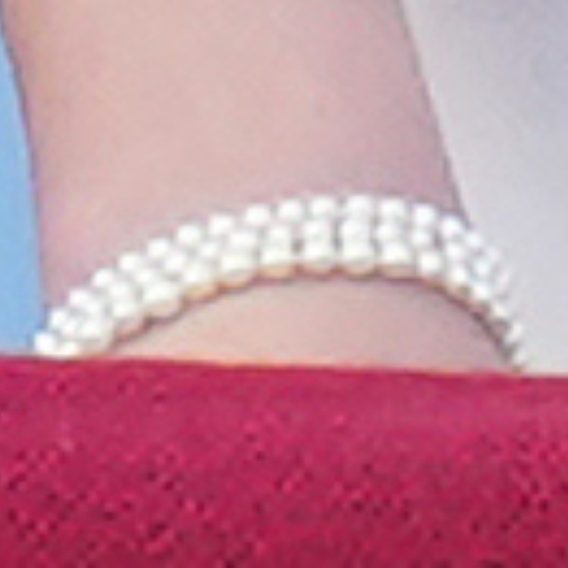Princess Charlotte wearing a three-strand pearl bracelet, echoing her mother's