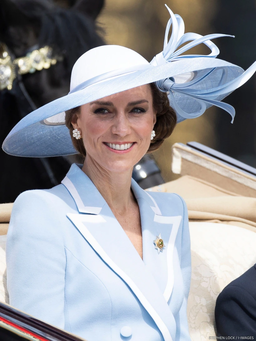 a powder blue Catherine Walker Lafayette coatdress and Philip Treacy hat