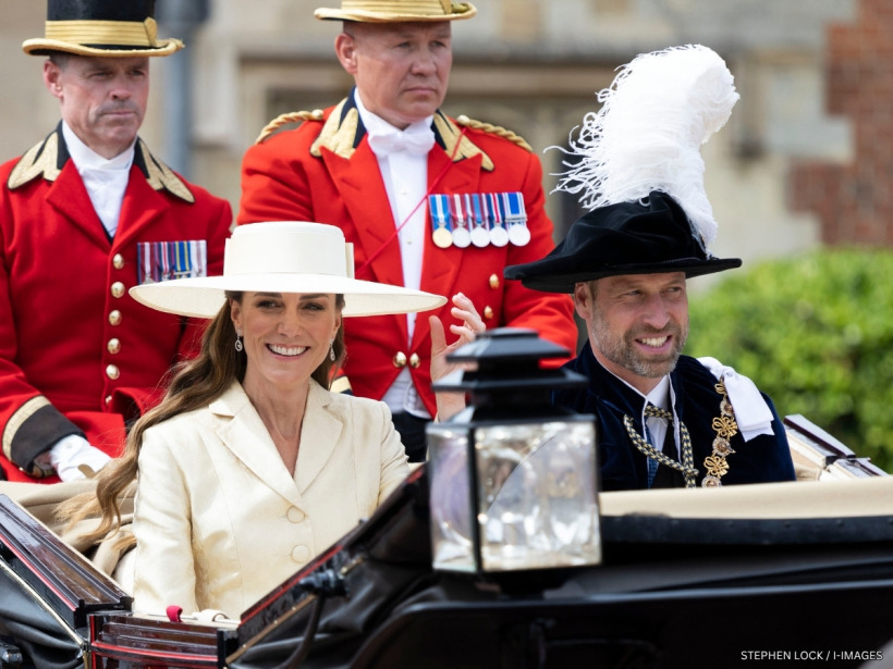 The Prince and Princess of Wales riding together in a carriage and waving to crowds on Garter Day