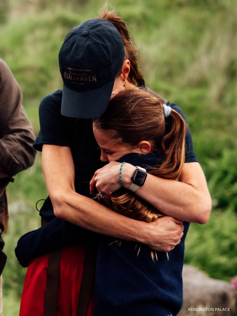 Kate Middleton embracing Princess Charlotte at the finish line of the Three Peaks Challenge