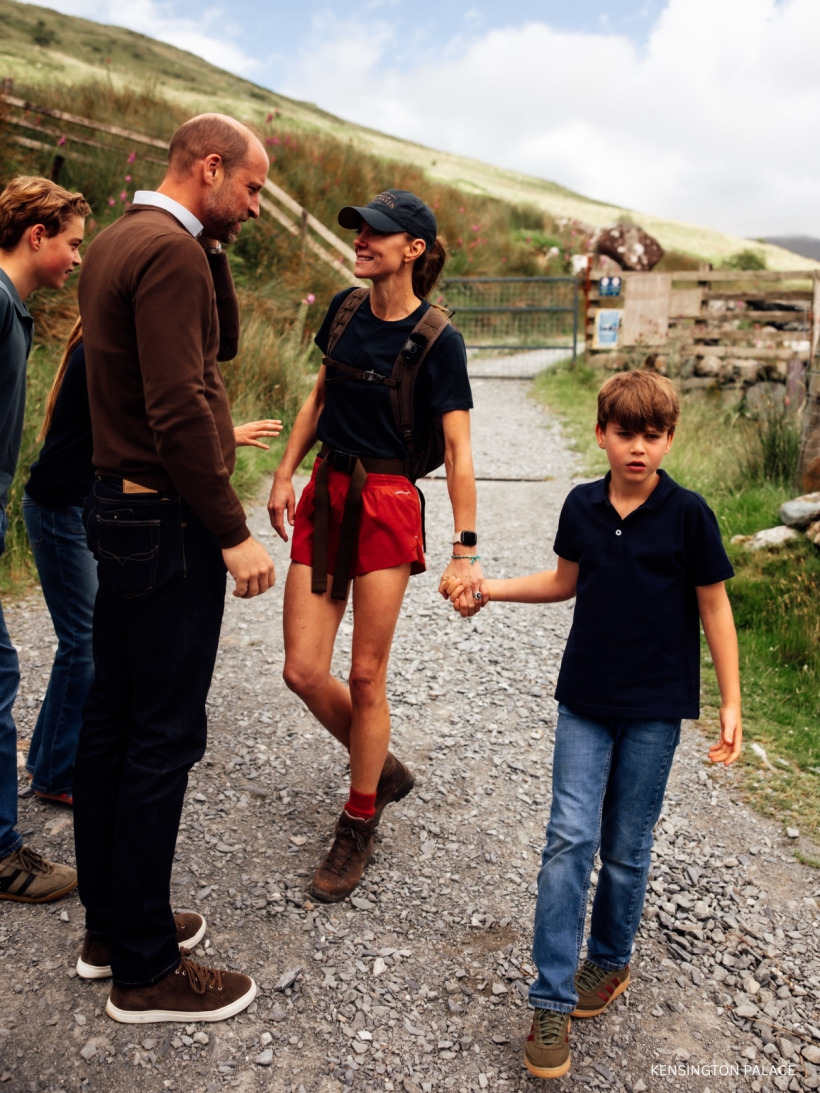 Kate Middleton talking with her family while holding Prince Louis's hand at the end of the Three Peaks Challenge