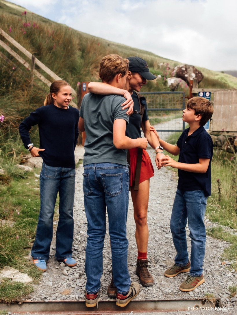 Kate Middleton hugging Prince George while chatting with Prince Louis and Princess Charlotte