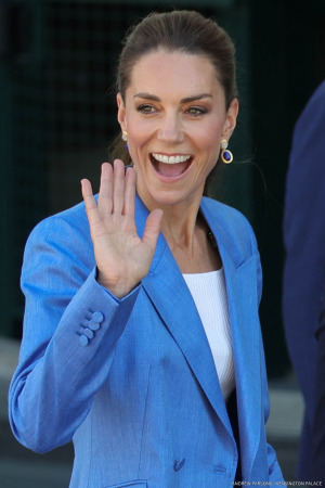 Kate Middleton, wearing a blue suit, waving to the camera