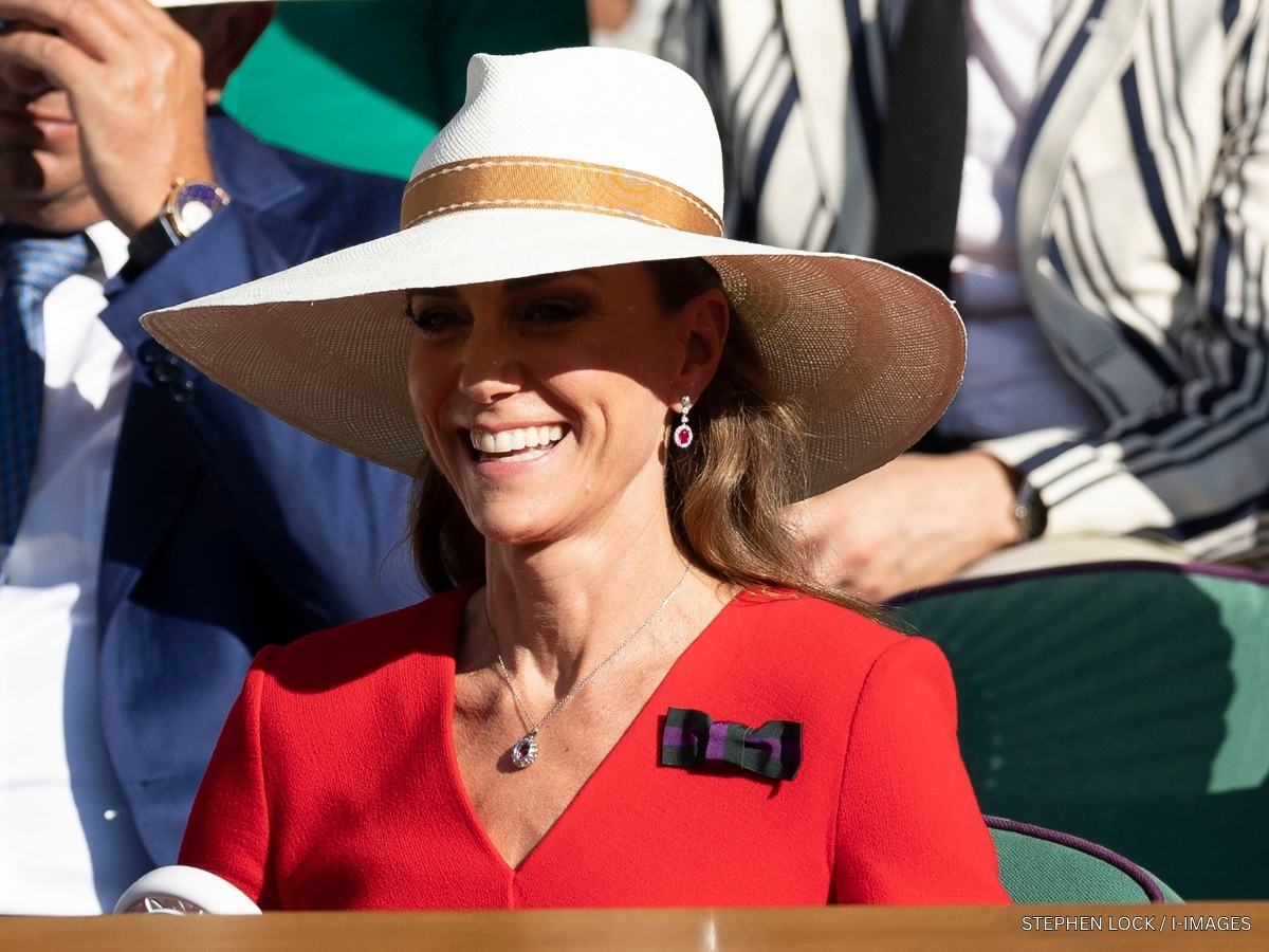 Kate Middleton wearing a wide-brimmed Panama hat trimmed with a tan ribbon