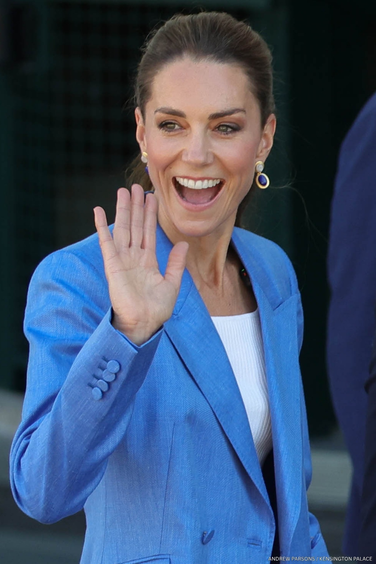 Kate Middleton, wearing a blue suit, waving to the camera