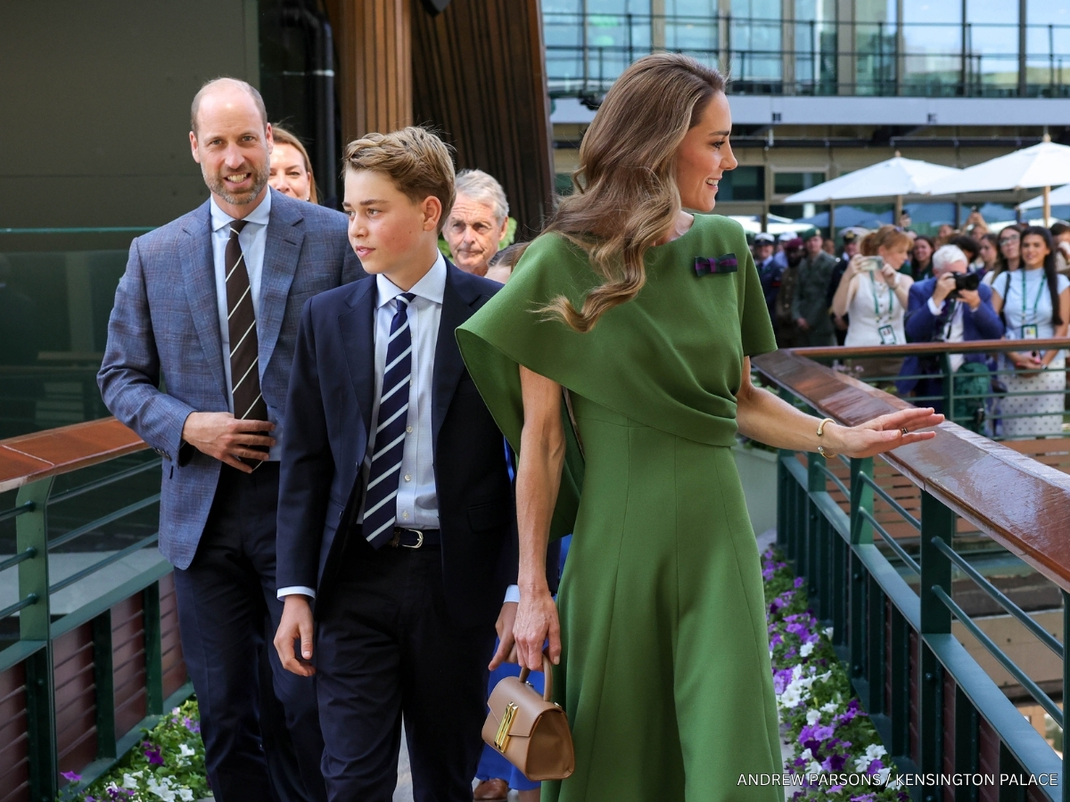 The Wales family crossing a bridge at the All England Club, with Prince William and Prince George in suits