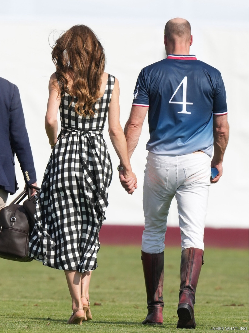 Prince William and Kate Middleton walking hand in hand across the polo pitch