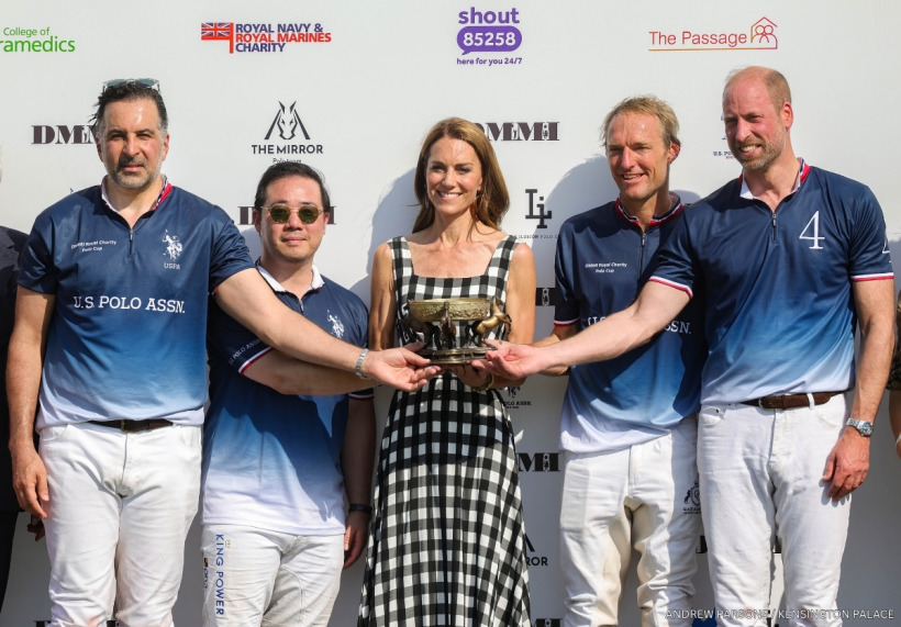 Kate Middleton holding the trophy with Prince William's winning polo team