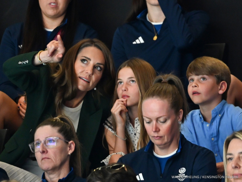 Kate Middleton pointing something out to Princess Charlotte and Prince Louis