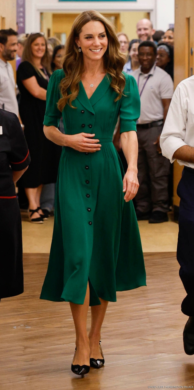 Kate Middleton wearing an emerald green Suzannah London 'Flippy Wiggle' dress with black slingback shoes