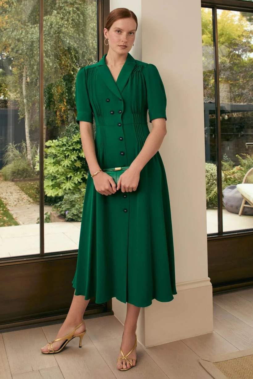 Front view of the Suzannah London 'Flippy Wiggle' dress in emerald green on a model